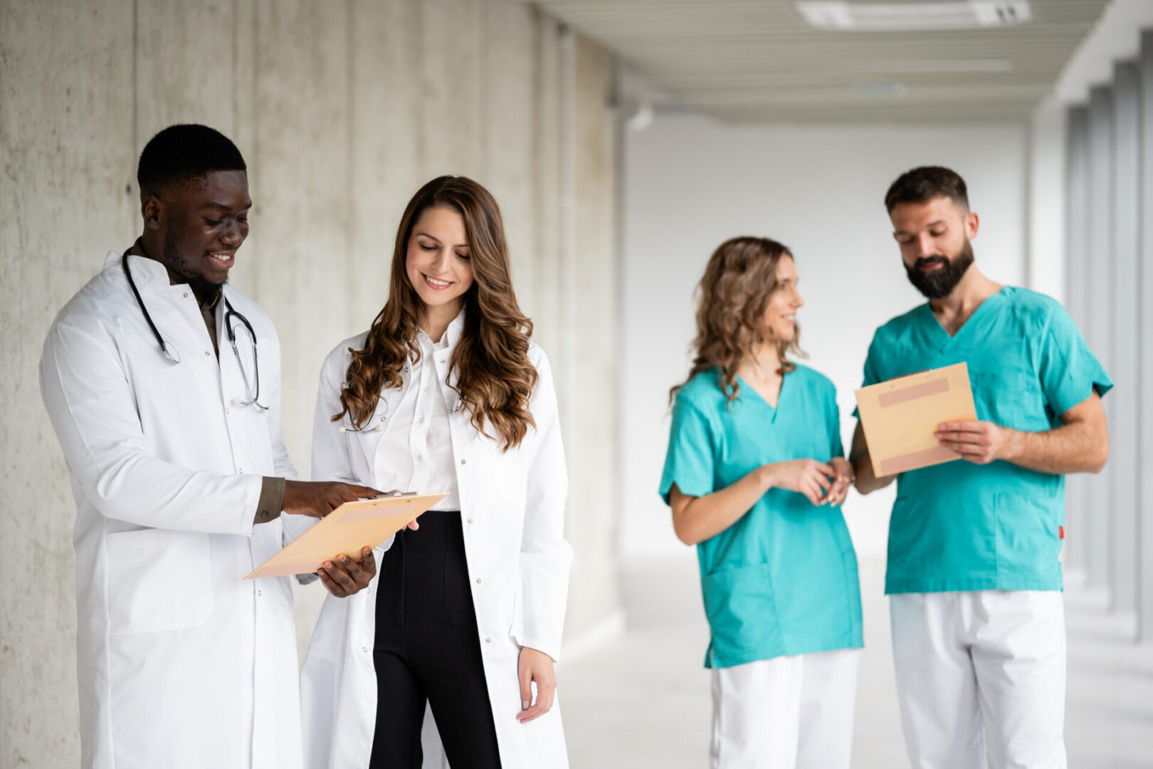 Doctors discussing medical files in hallway