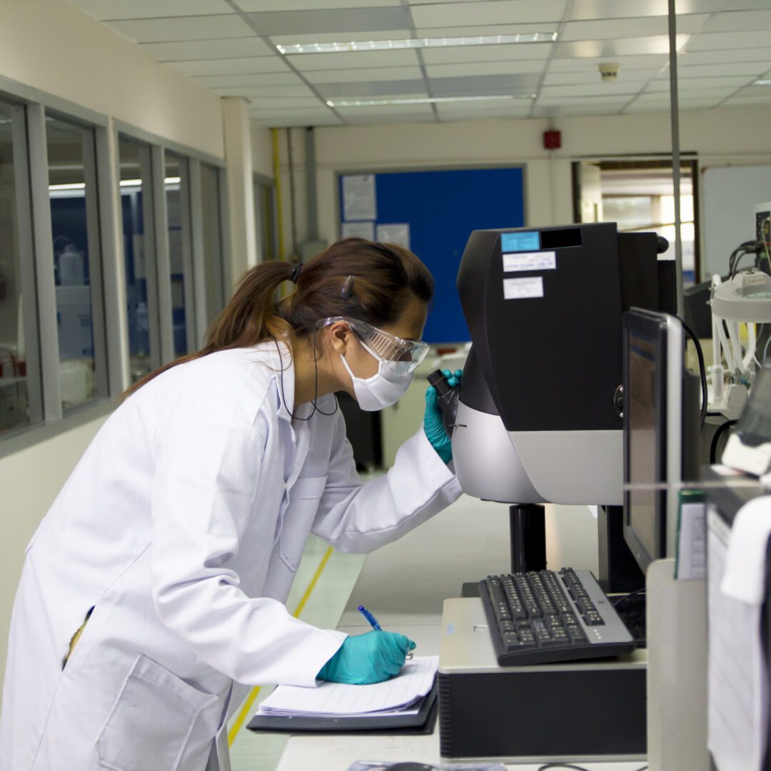 Lab technician wearing safety goggles working