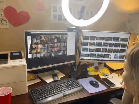 Woman working at a cluttered desk