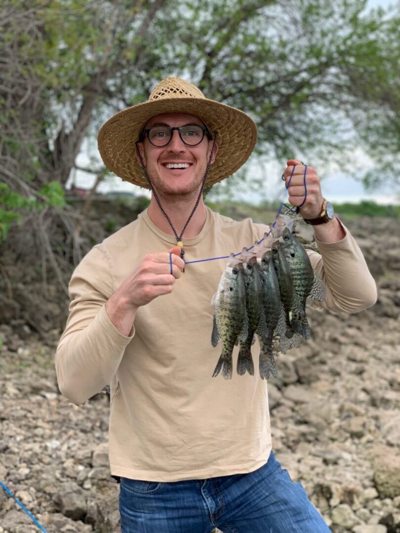 Man holding string of freshly caught fish