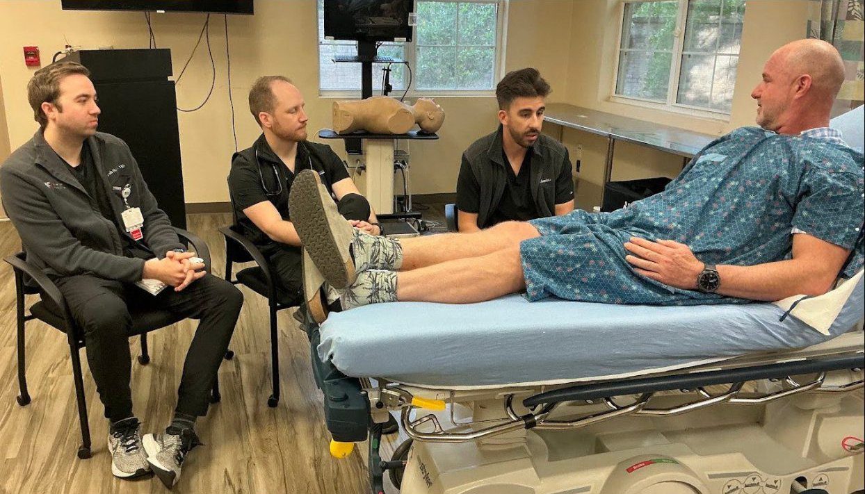 Healthcare professionals meeting with hospitalized patient