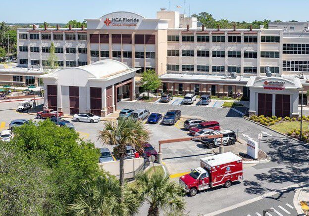 Aerial view of hospital and parking area.
